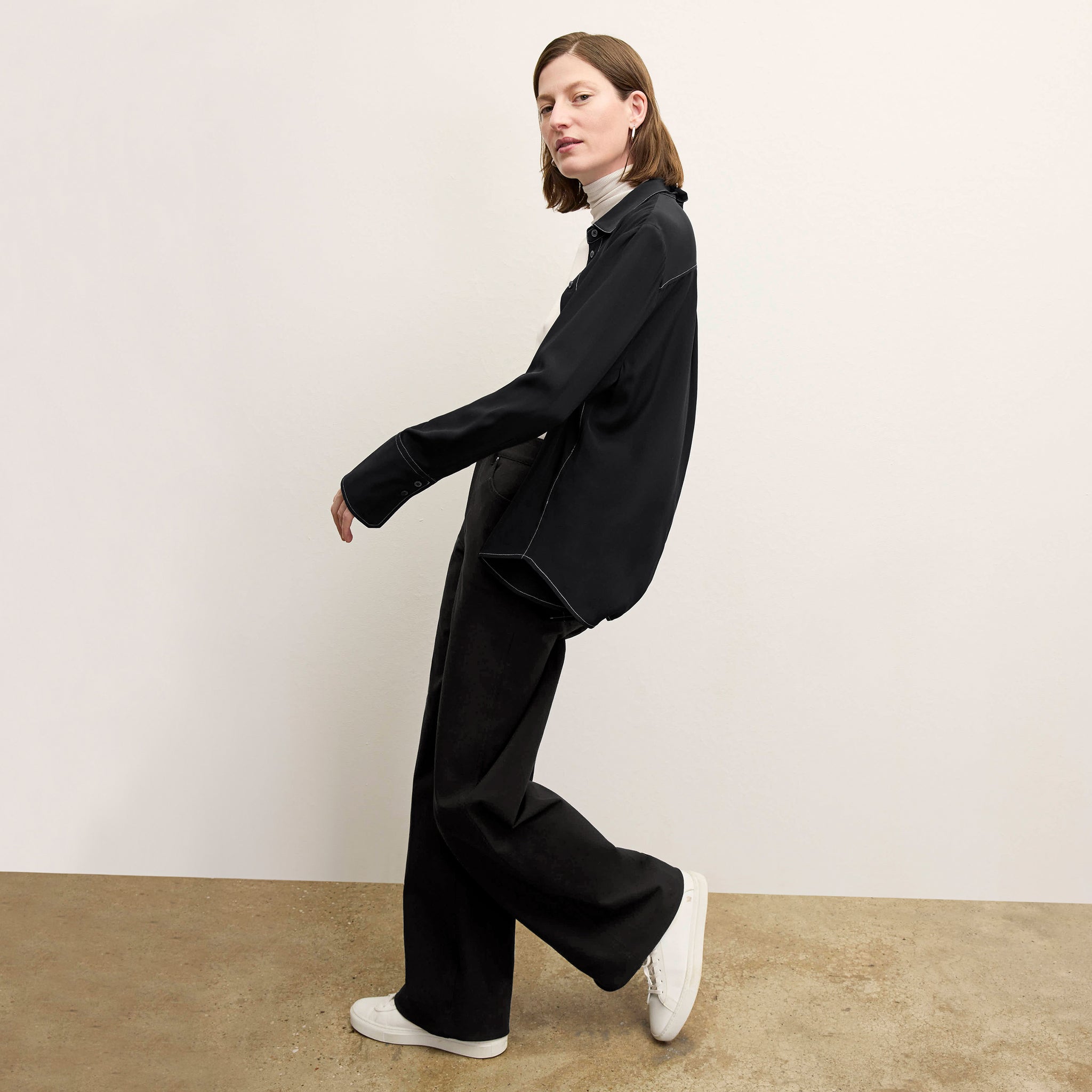 side image of a woman wearing the mira top in black