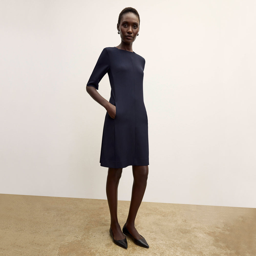 Front image of a woman wearing the emily dress in midnight