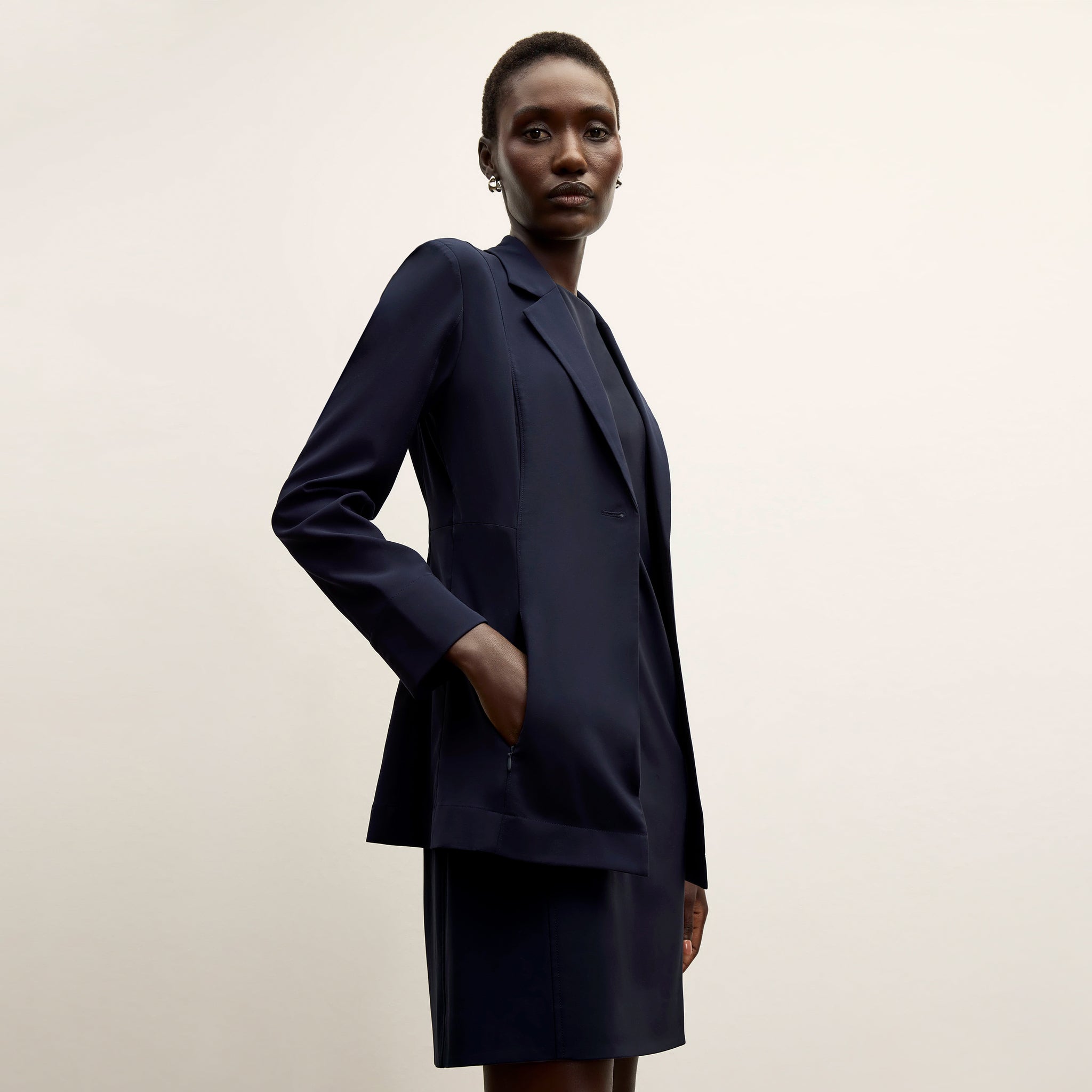 front image of a woman wearing the moreland jacket in dark navy