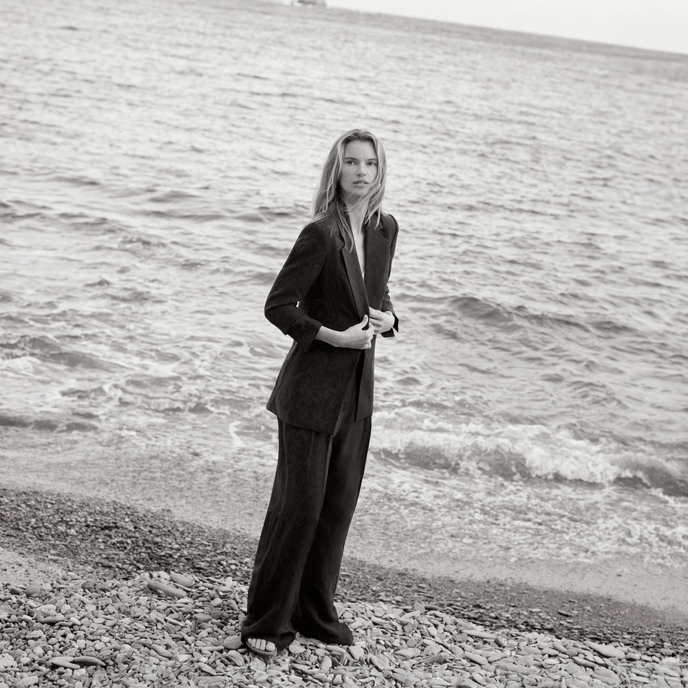 women in navy blue suit on the beach