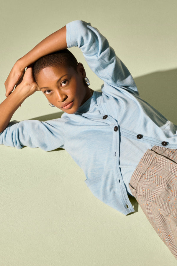 front image of a woman wearing the rosalia cardigan in morning sky 