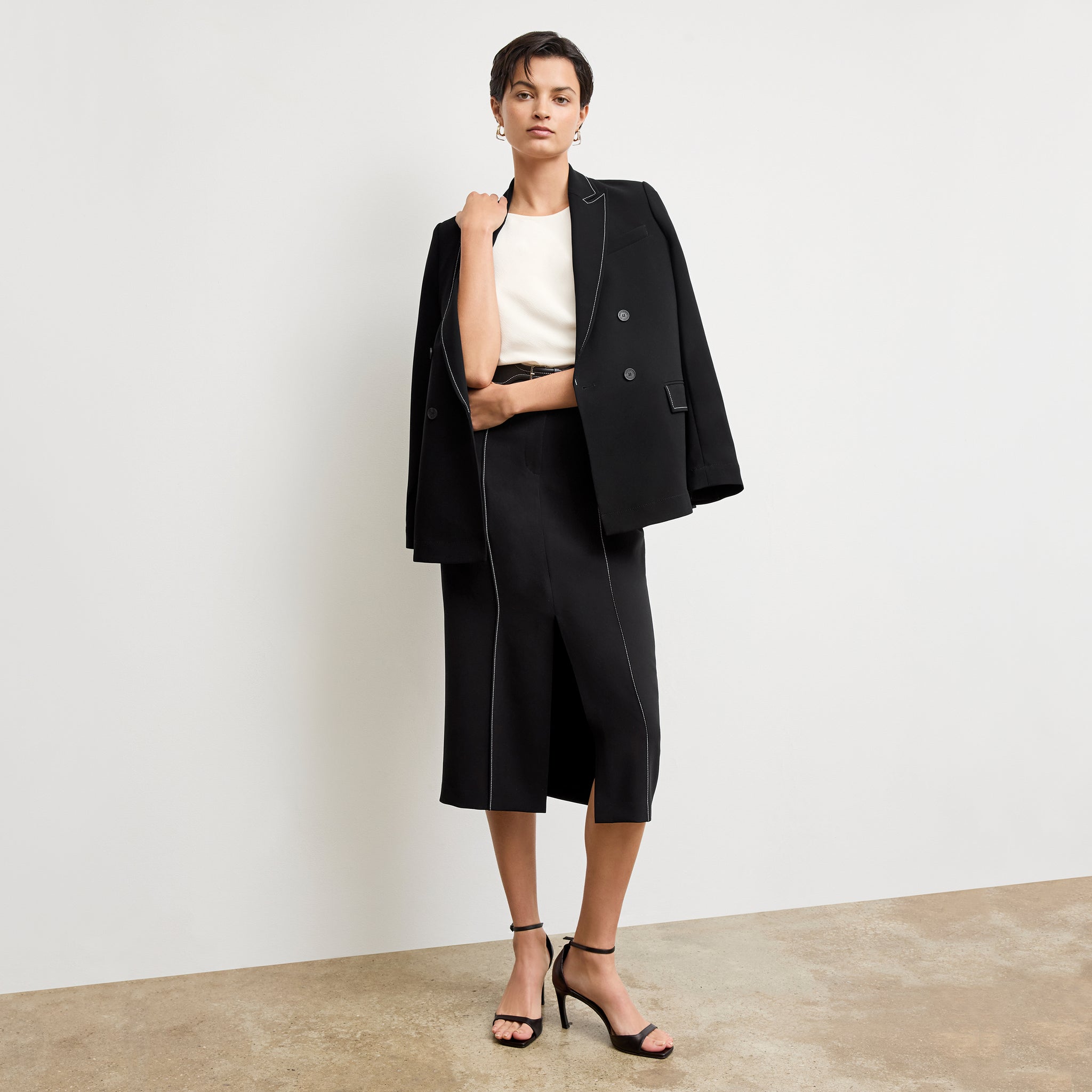 front image of a woman wearing the meghan skirt in black with topstitch