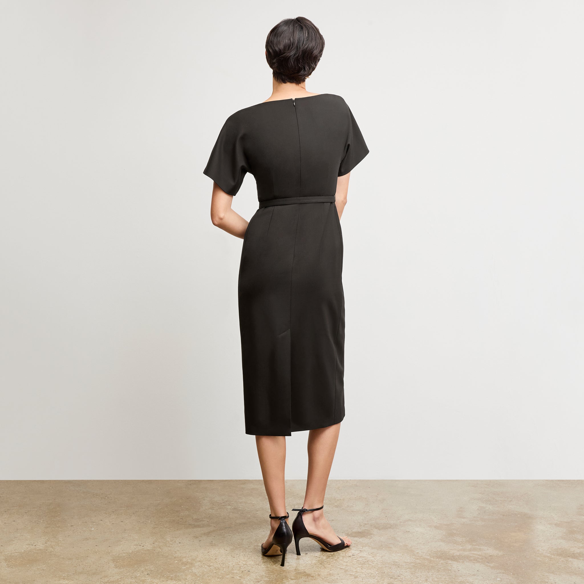 back image of a woman wearing the meredith dress in black