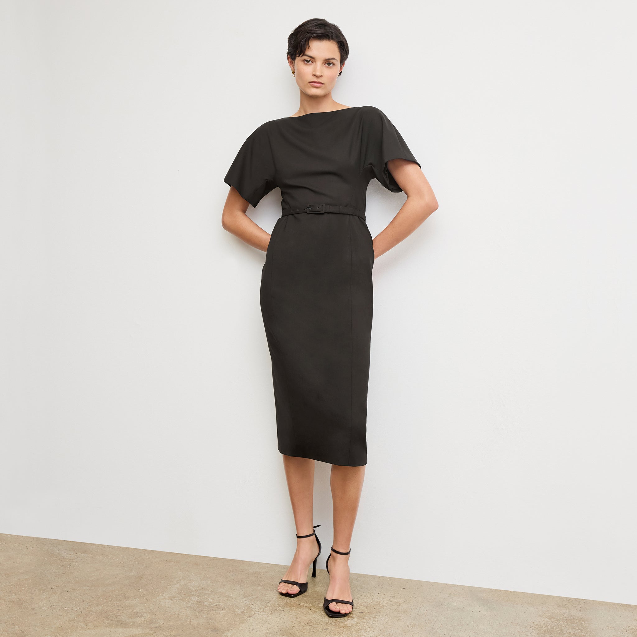 front image of a woman wearing the meredith dress in black 