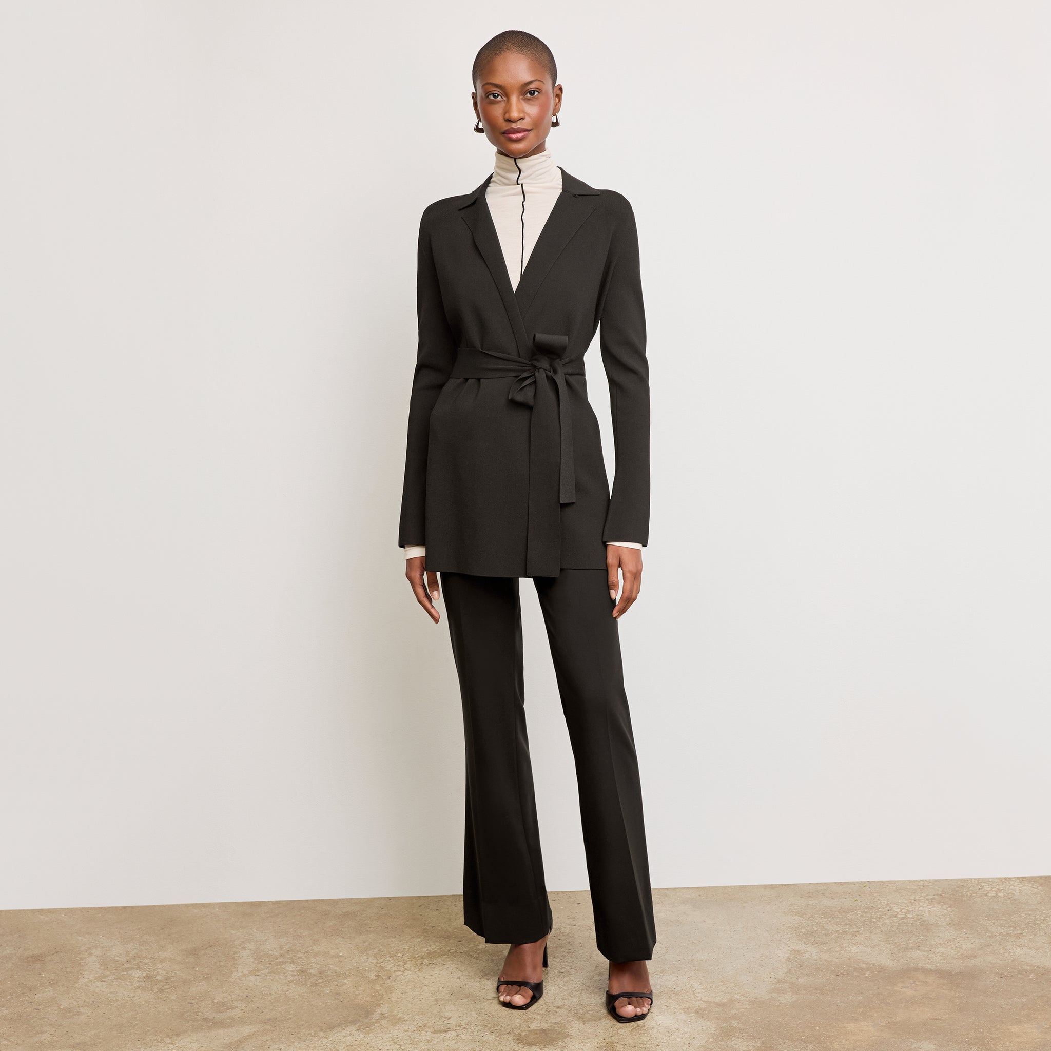 Front image of a woman standing wearing the Merritt jardigan in Black