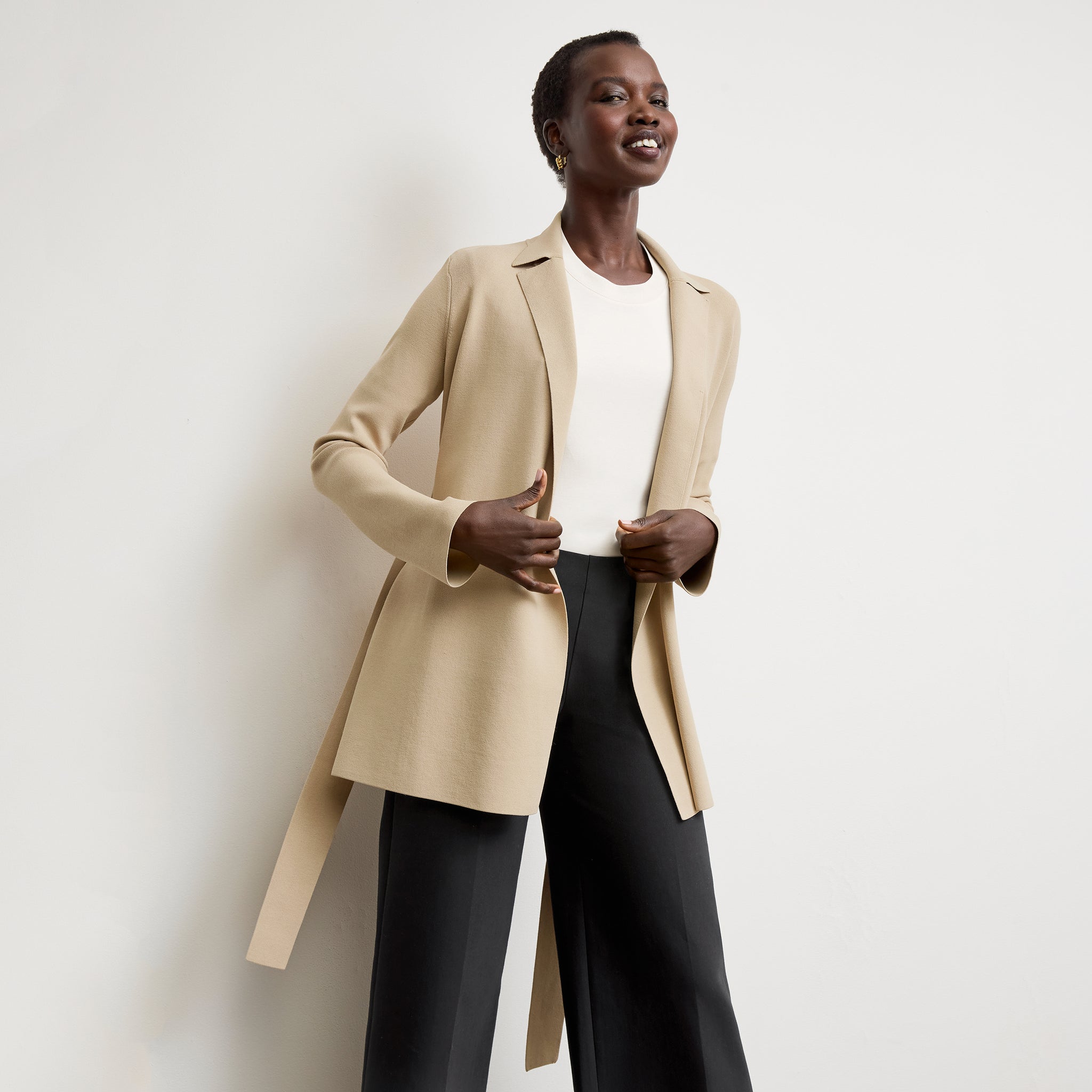 Front image of a woman standing wearing the Merritt jardigan in latte