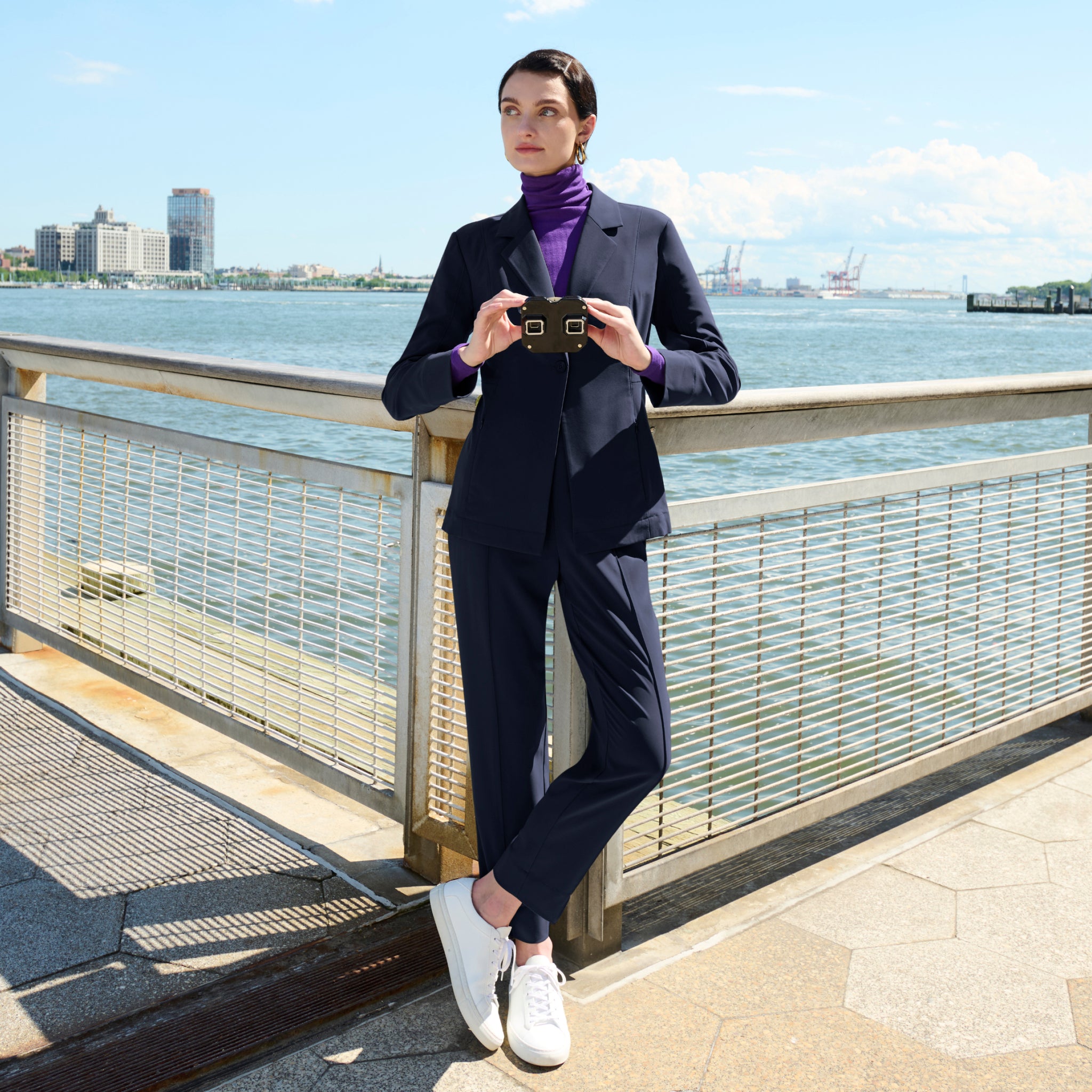 front image of a woman wearing the moreland jacket in dark navy