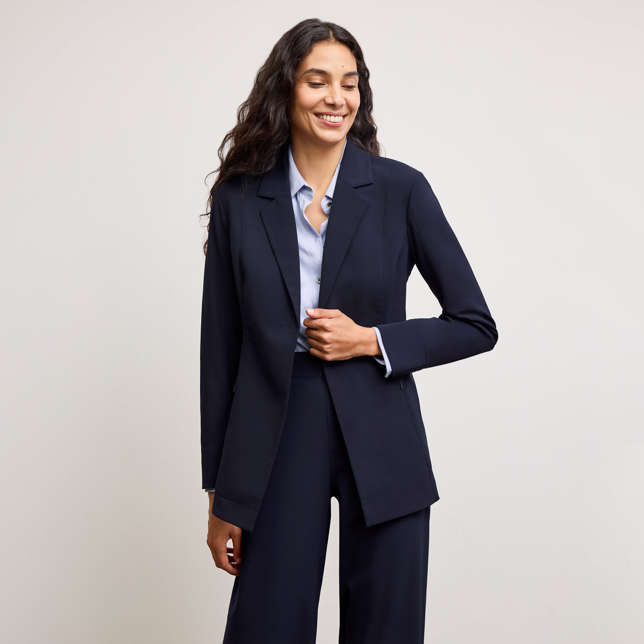 front image of a woman wearing the moreland jacket in dark navy 