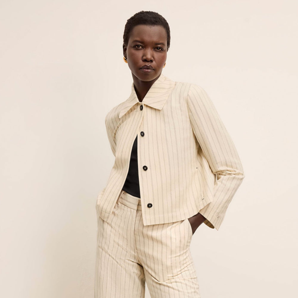 front image of a woman wearing the nicky jacket in linen stripe