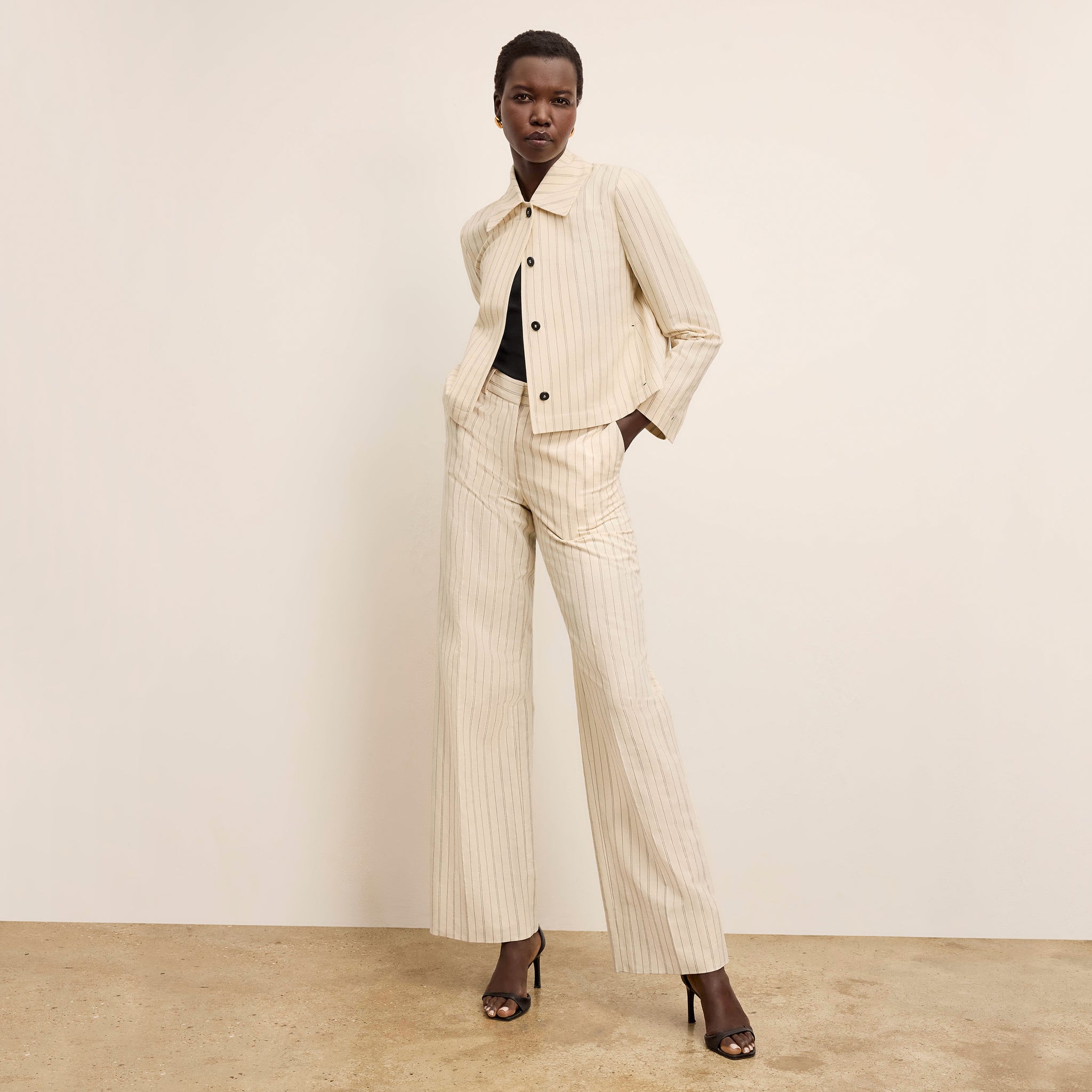 front image of a woman wearing the tinsley pant in linen stripe