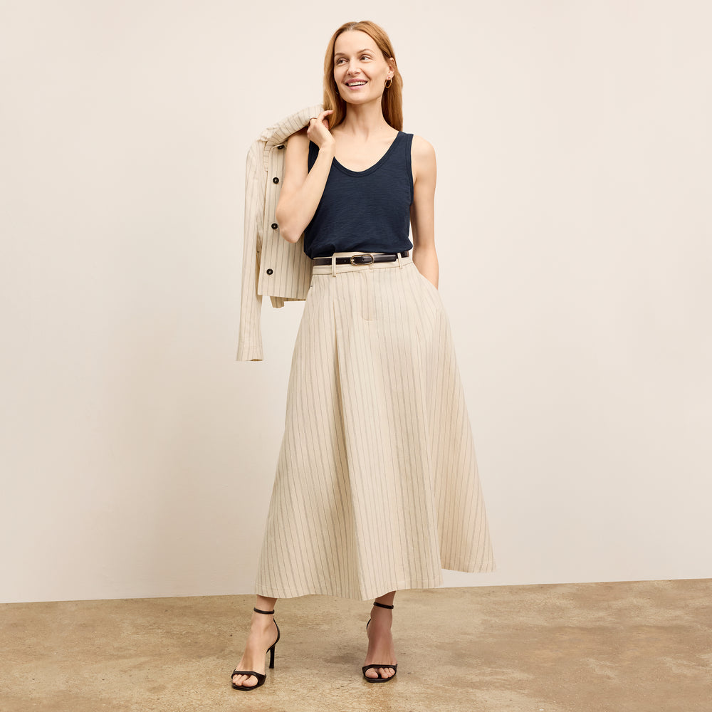 front image of a woman wearing the olia skirt in linen stripe