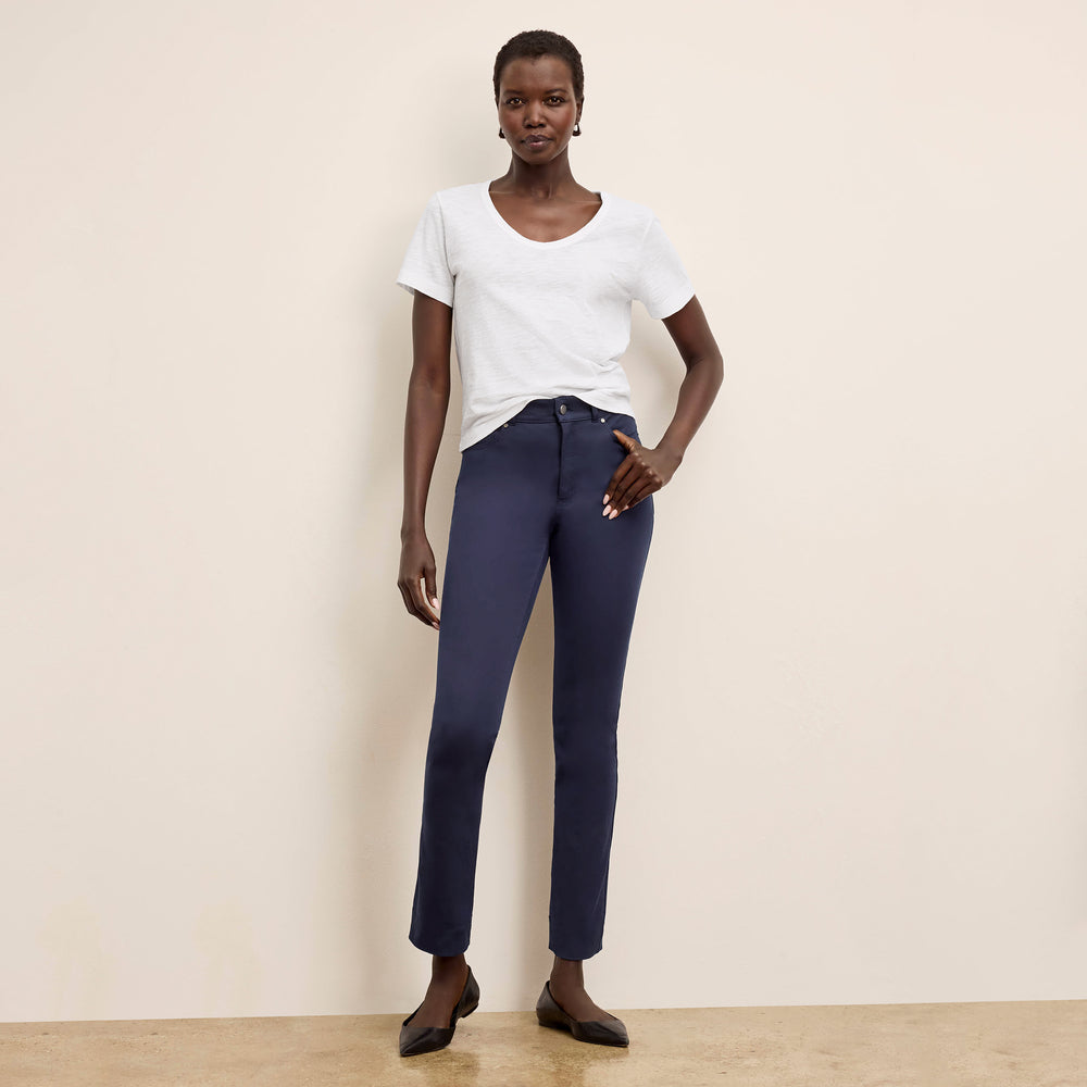 Front image of a woman wearing the roma pants in dark navy