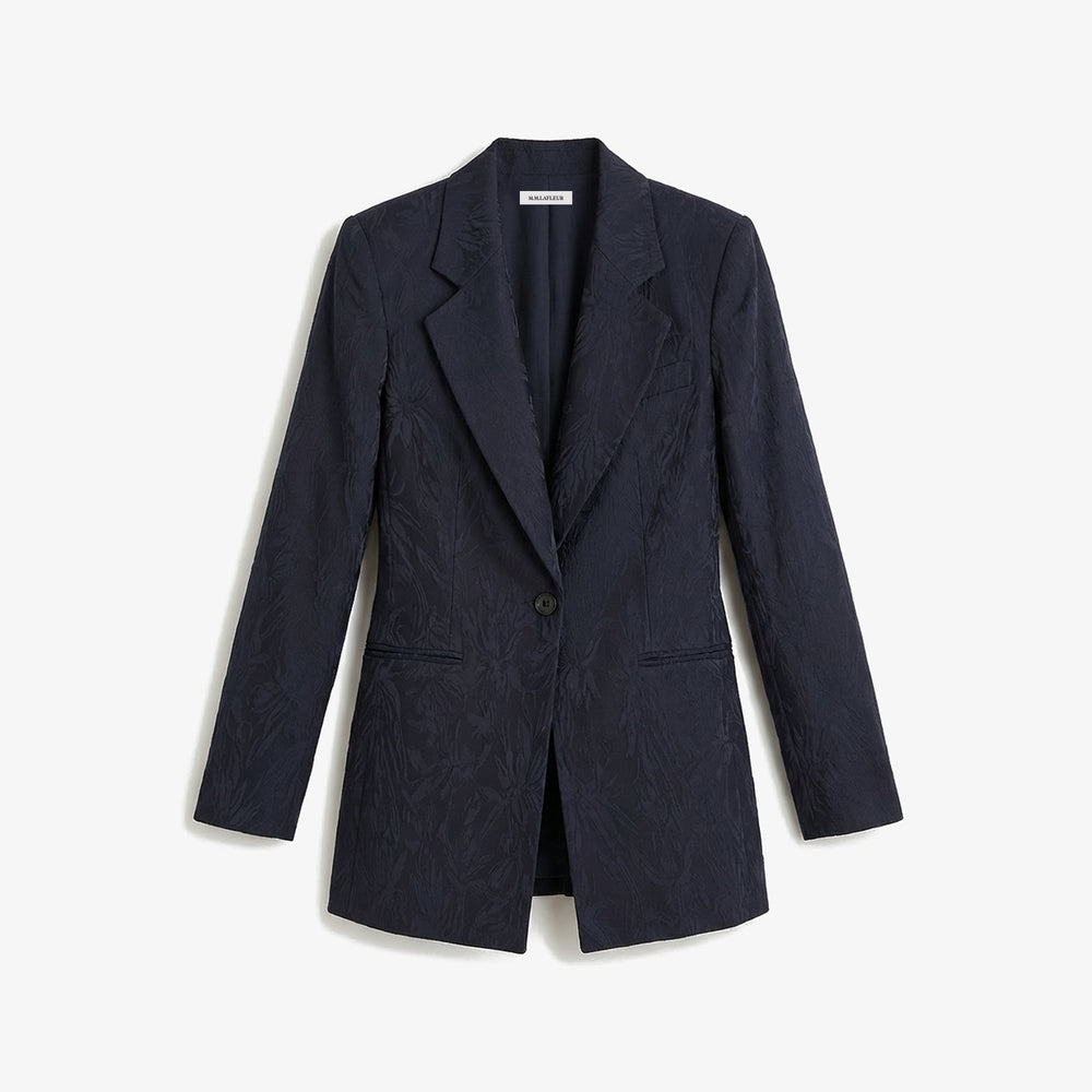 Navy blazer on a light gray background