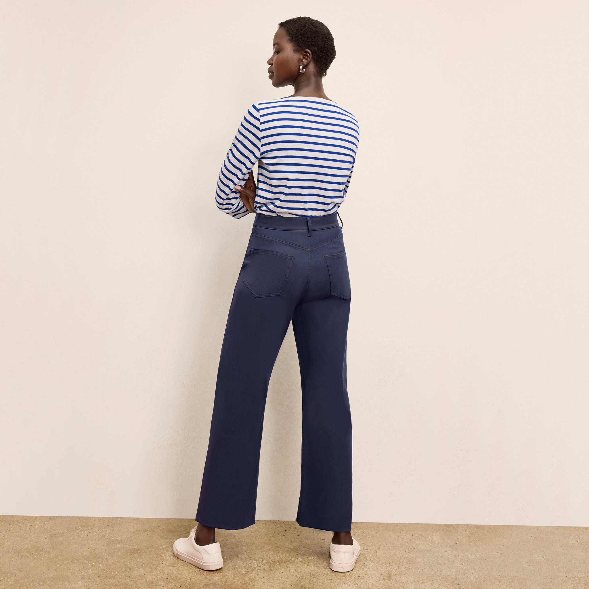 Backc image of a woman standing wearing the Milo Jean in ink