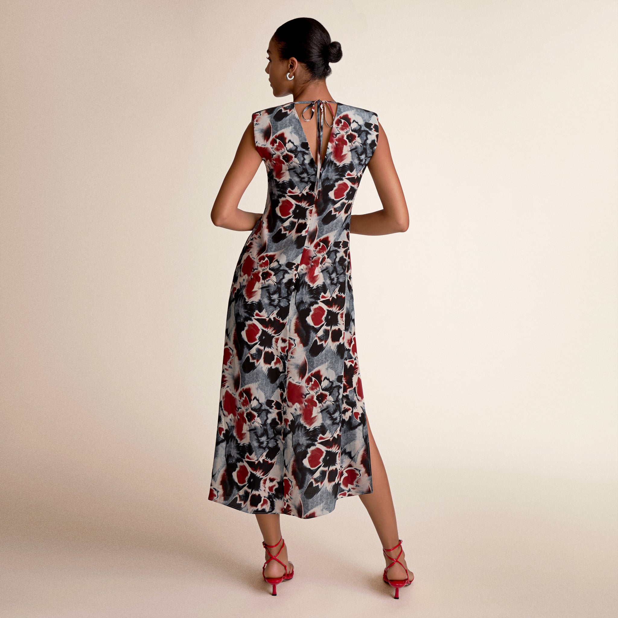 Woman wearing a floral dress on a beige background
