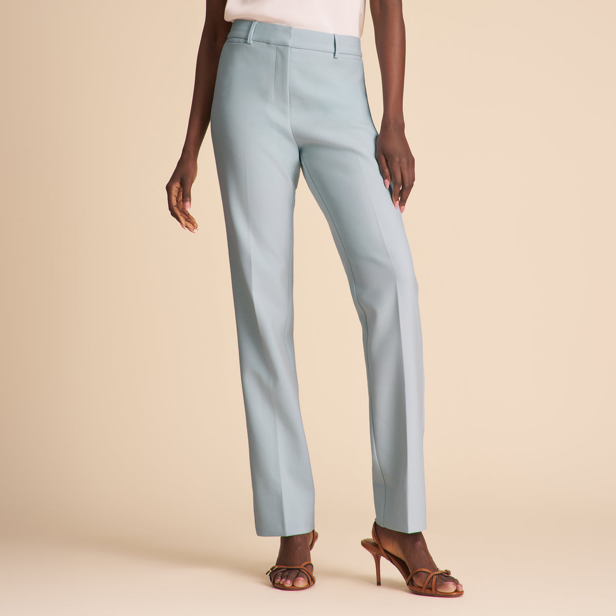 Light blue pants worn by a person on a beige background