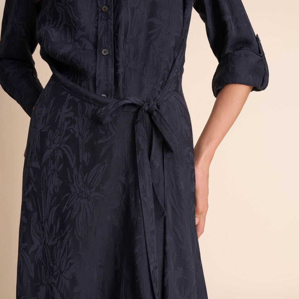 Navy blue dress with floral pattern on a beige background