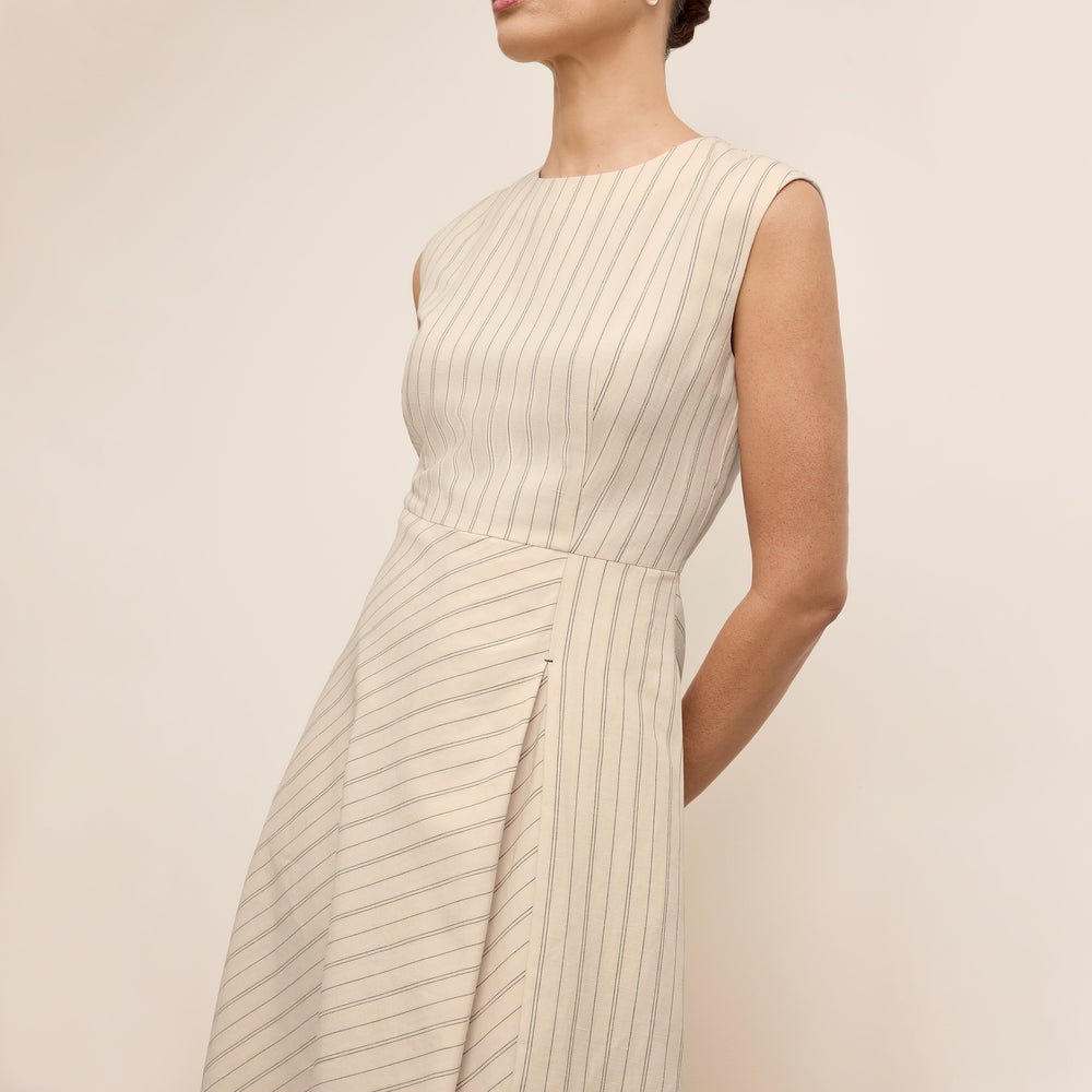 front image of a woman wearing the tati dress in linen stripe