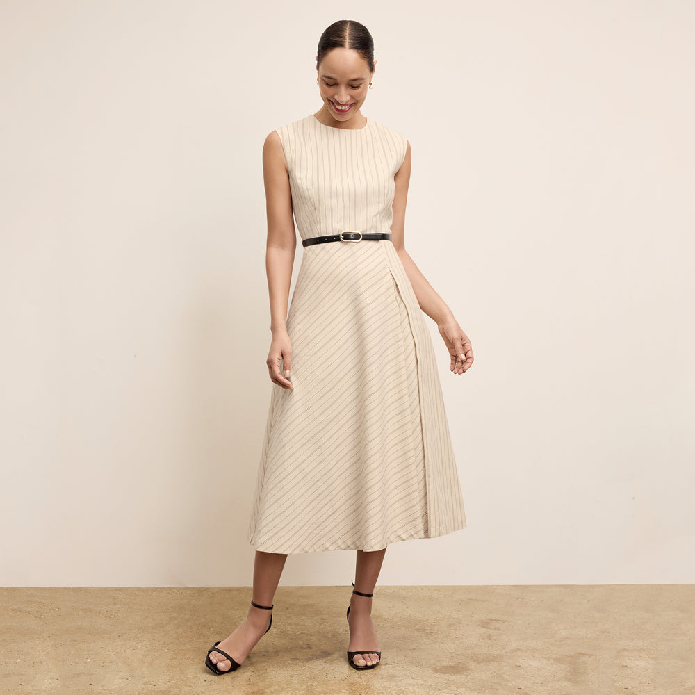 front image of a woman wearing the tati dress in linen stripe