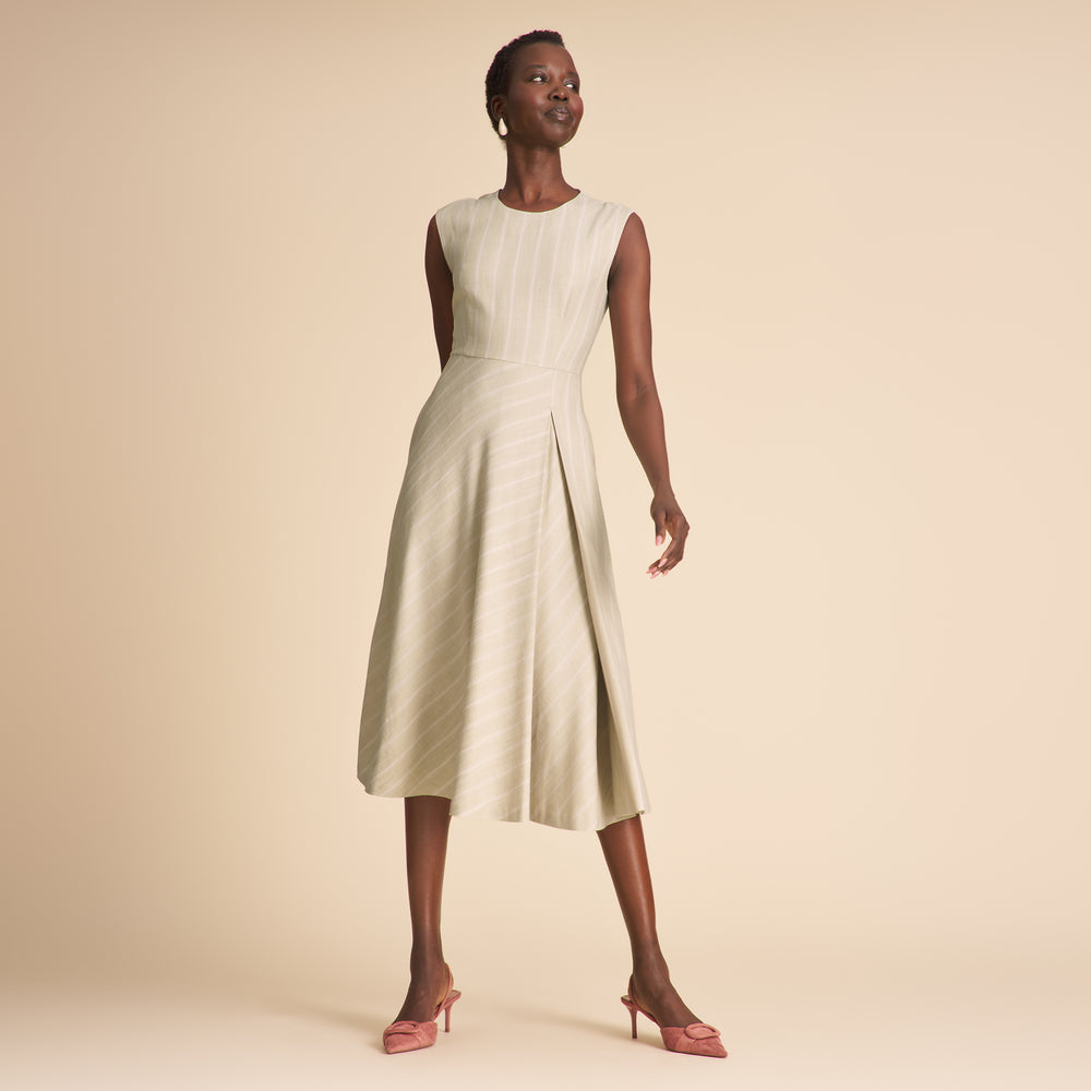Woman wearing a light green dress against a beige background