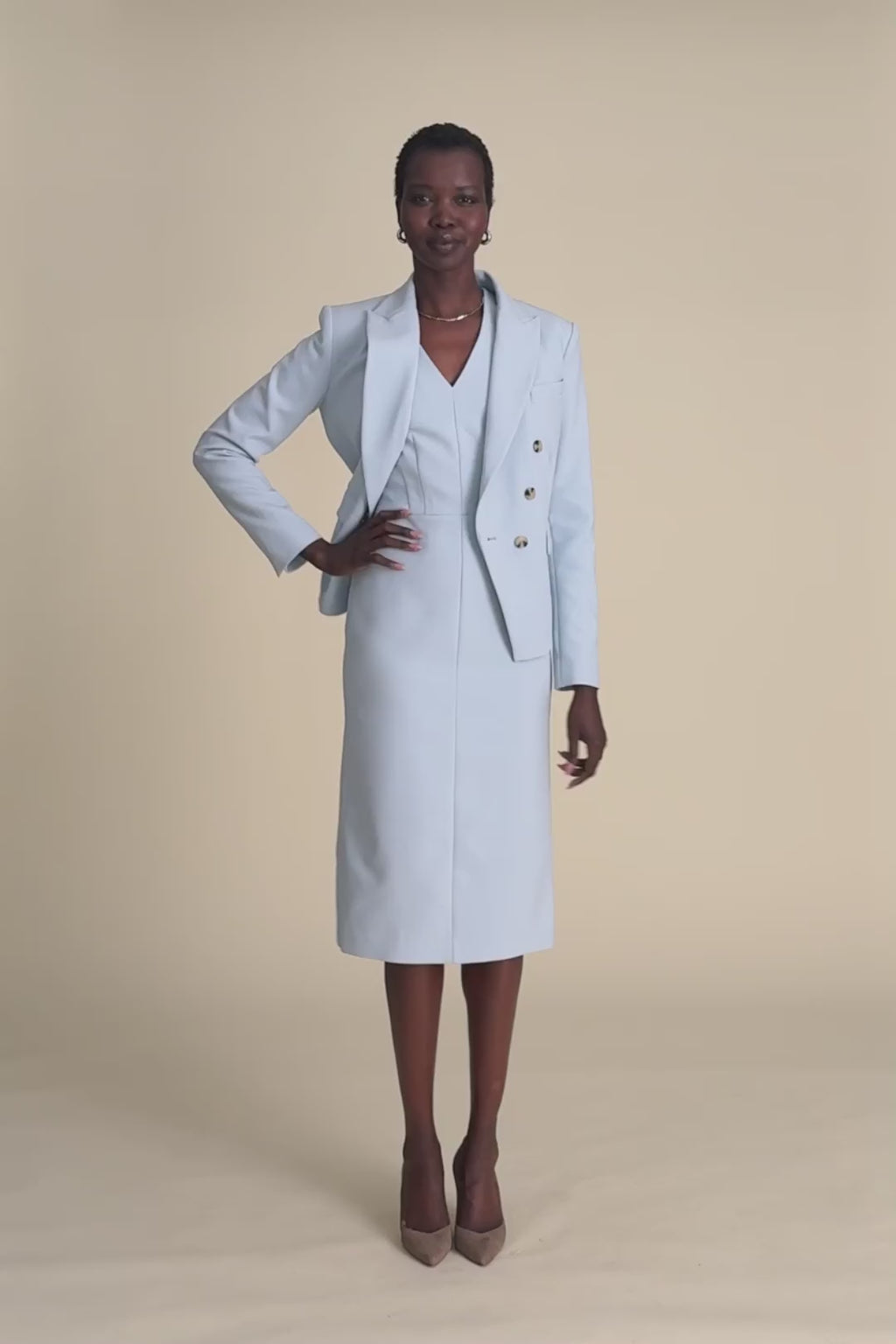 woman in light blue blazer with matching dress.