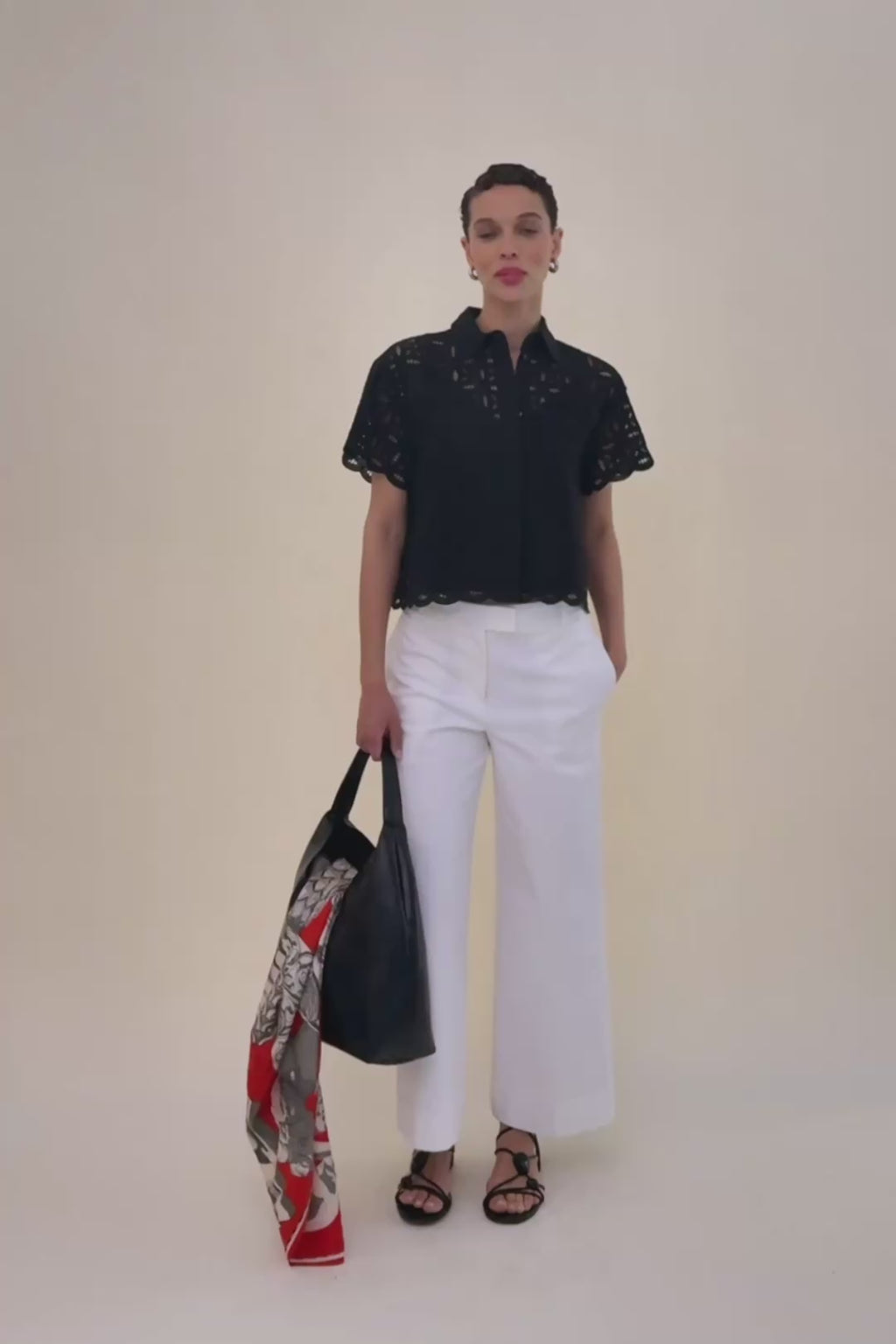woman in black blouse and white jeans. 