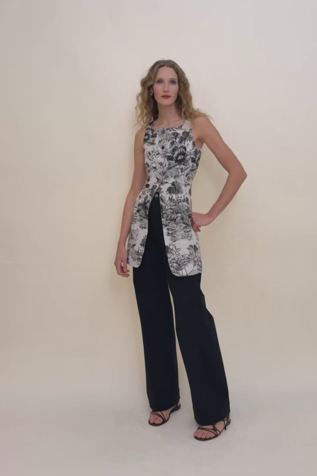woman in palm print dress with black jeans.