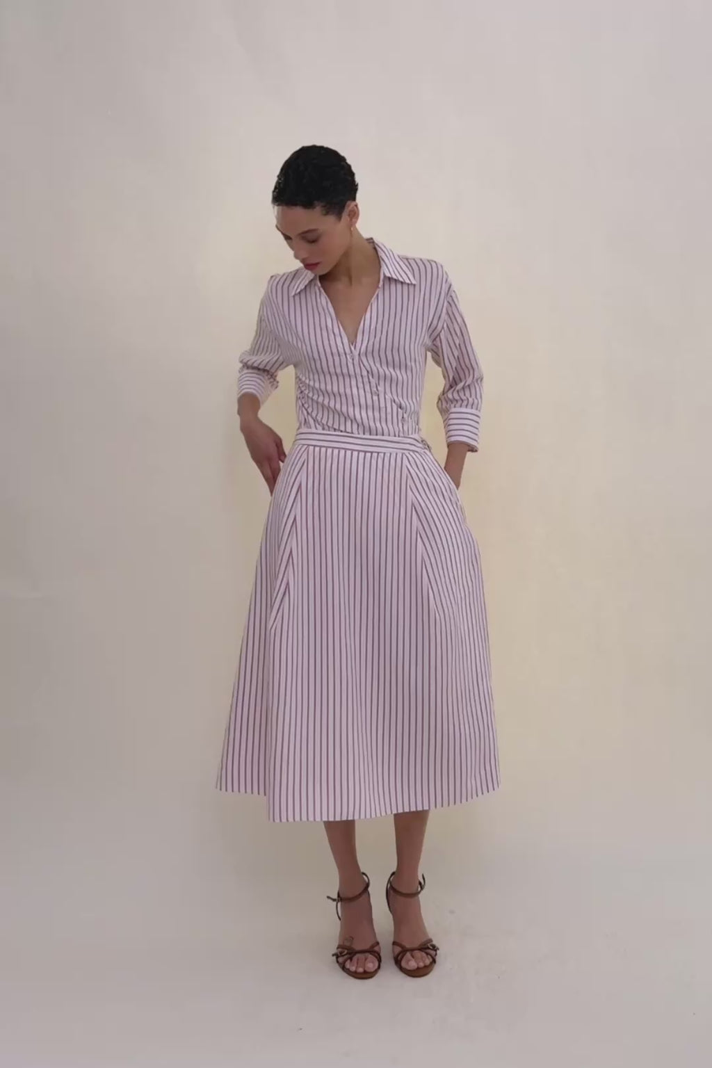 woman in stripped shirt and skirt.