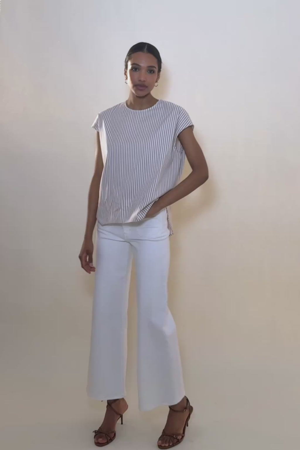 woman in stripped shirt with white jeans.