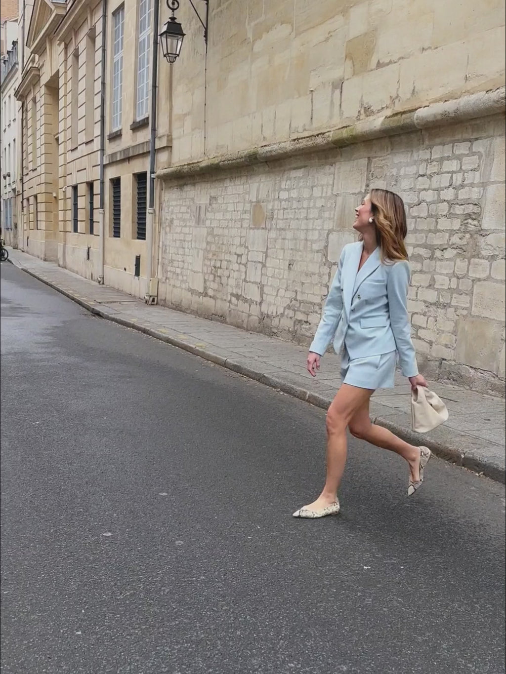 woman in light blue blazer with matching shorts