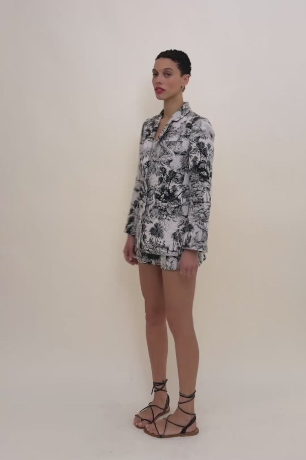 woman in palm print blazer and matching shorts.