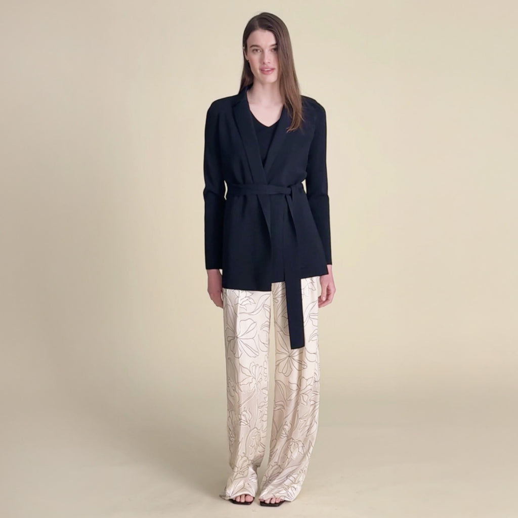 woman in black jardigan and white satin pants . 