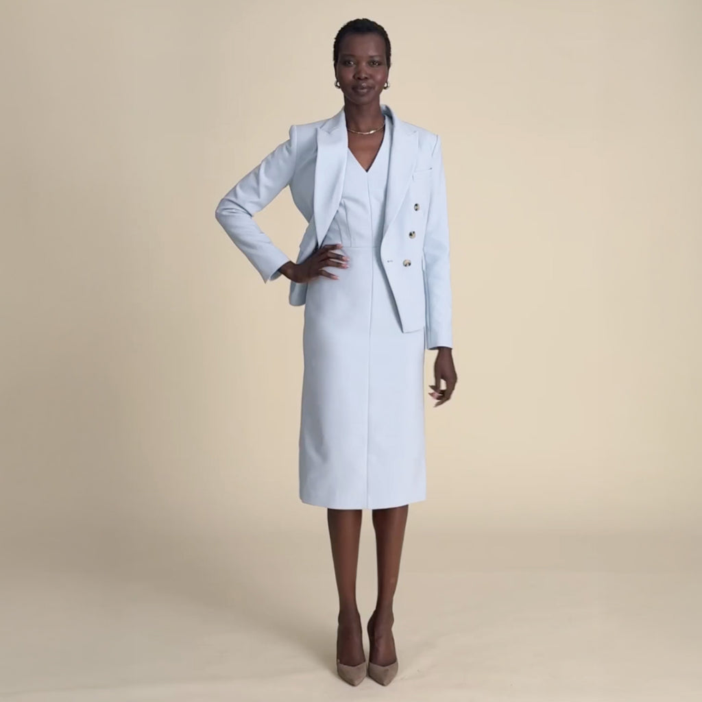 woman in light blue blazer with matching dress