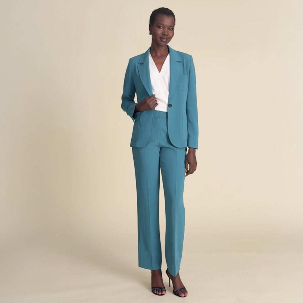 woman in teal blazer with matching pants