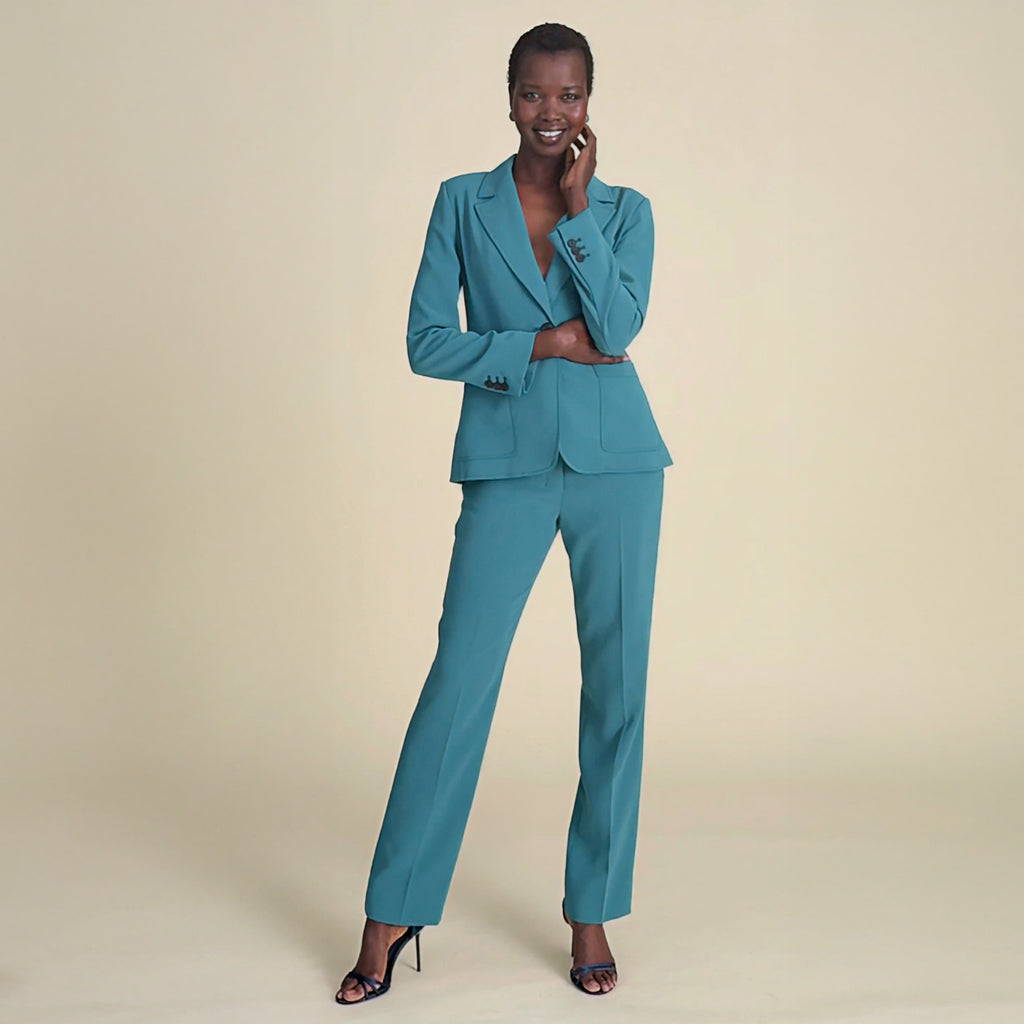 woman in teal blazer with matching pants