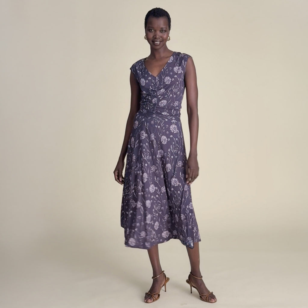woman in purple top with matching skirt