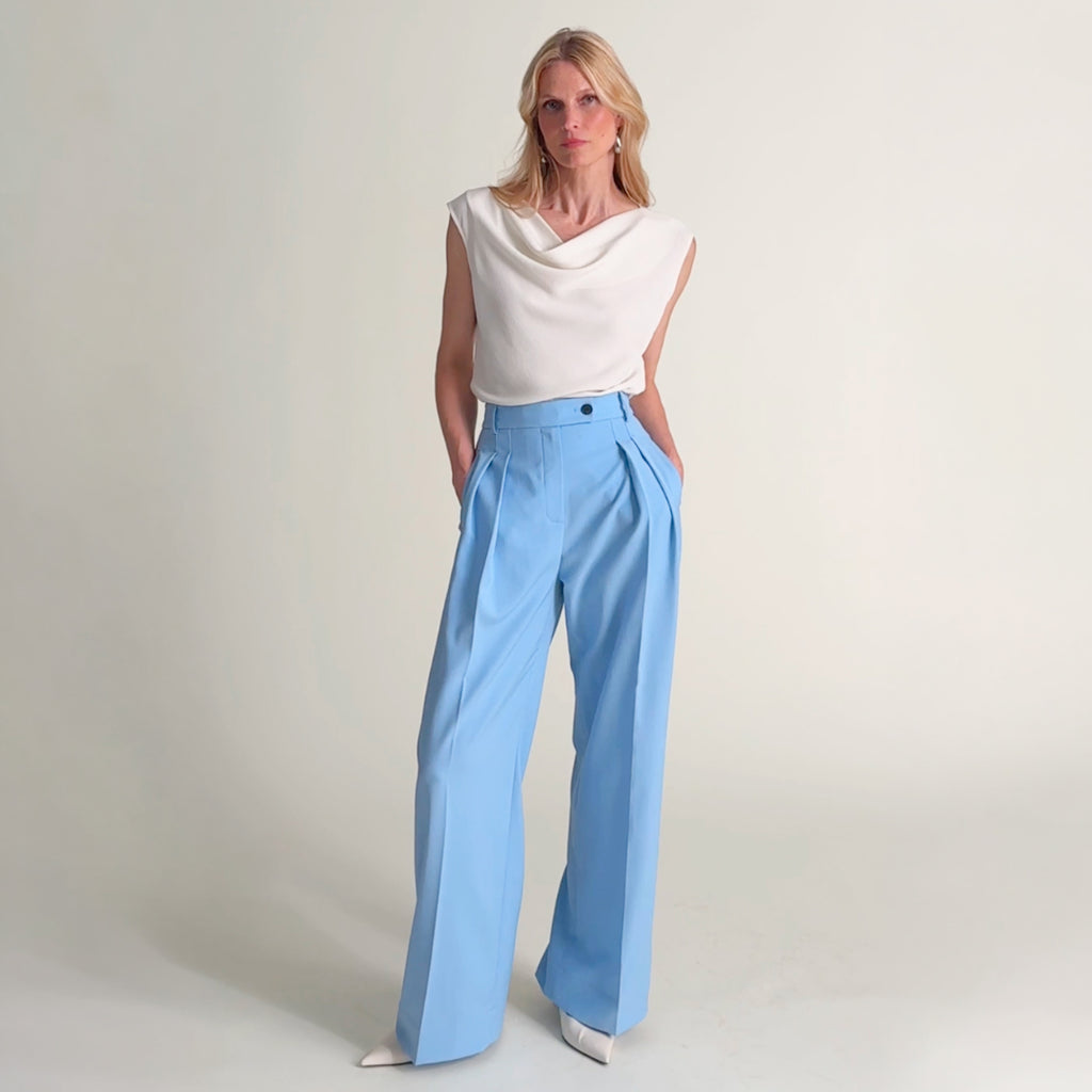 Woman wearing the Nora top in ivory and Bia pant in Clear Sky
