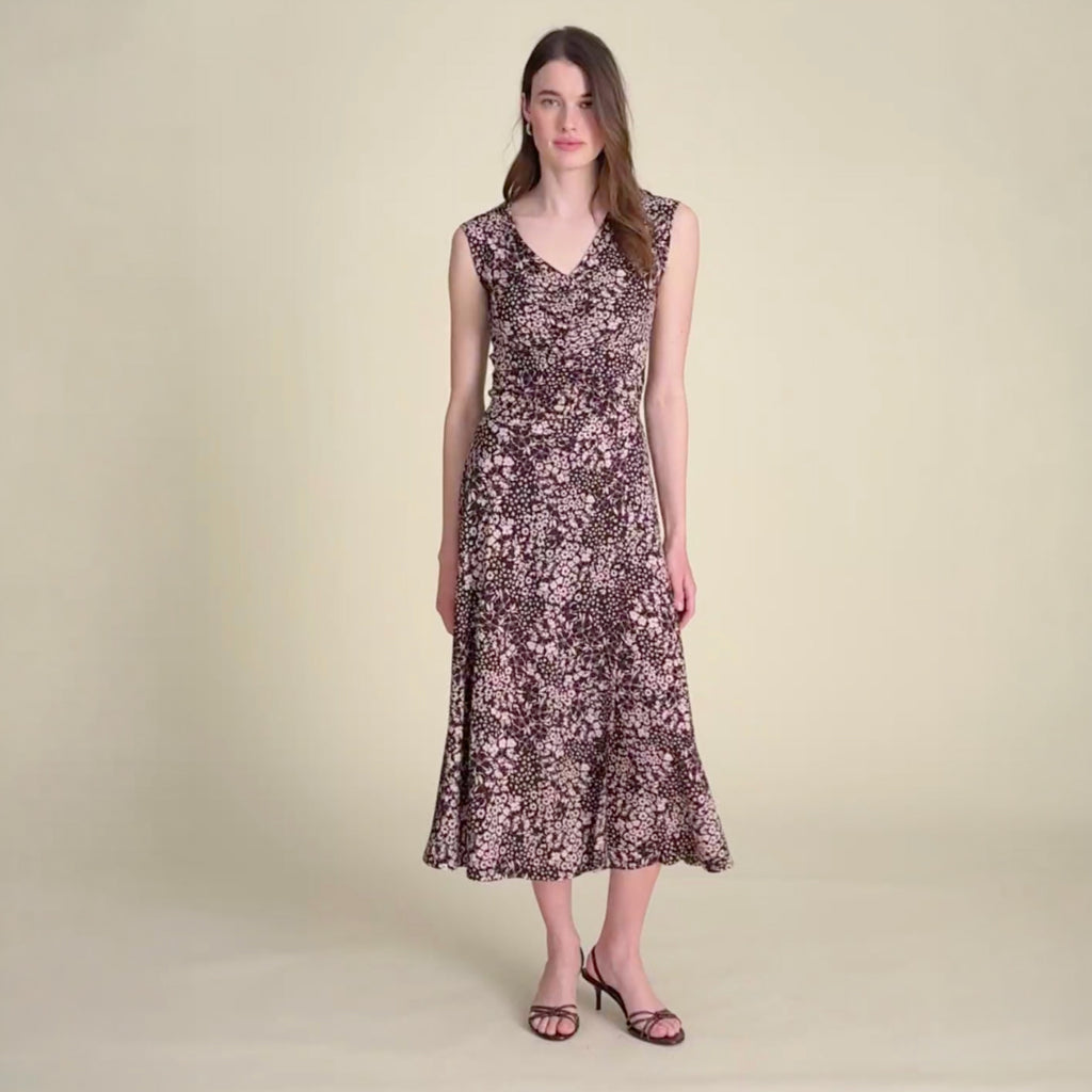 Video of a a woman wearing a floral tank top and matching floral skirt