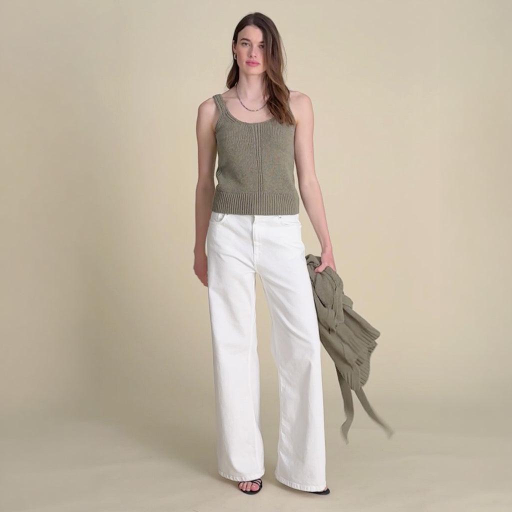 woman in green cardigan with white jeans. 