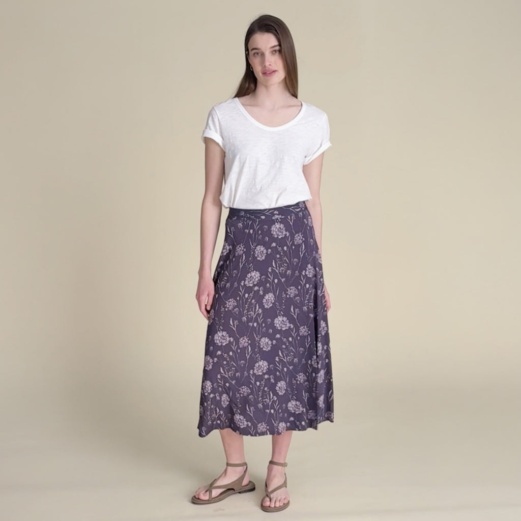 woman in white top with purple skirt