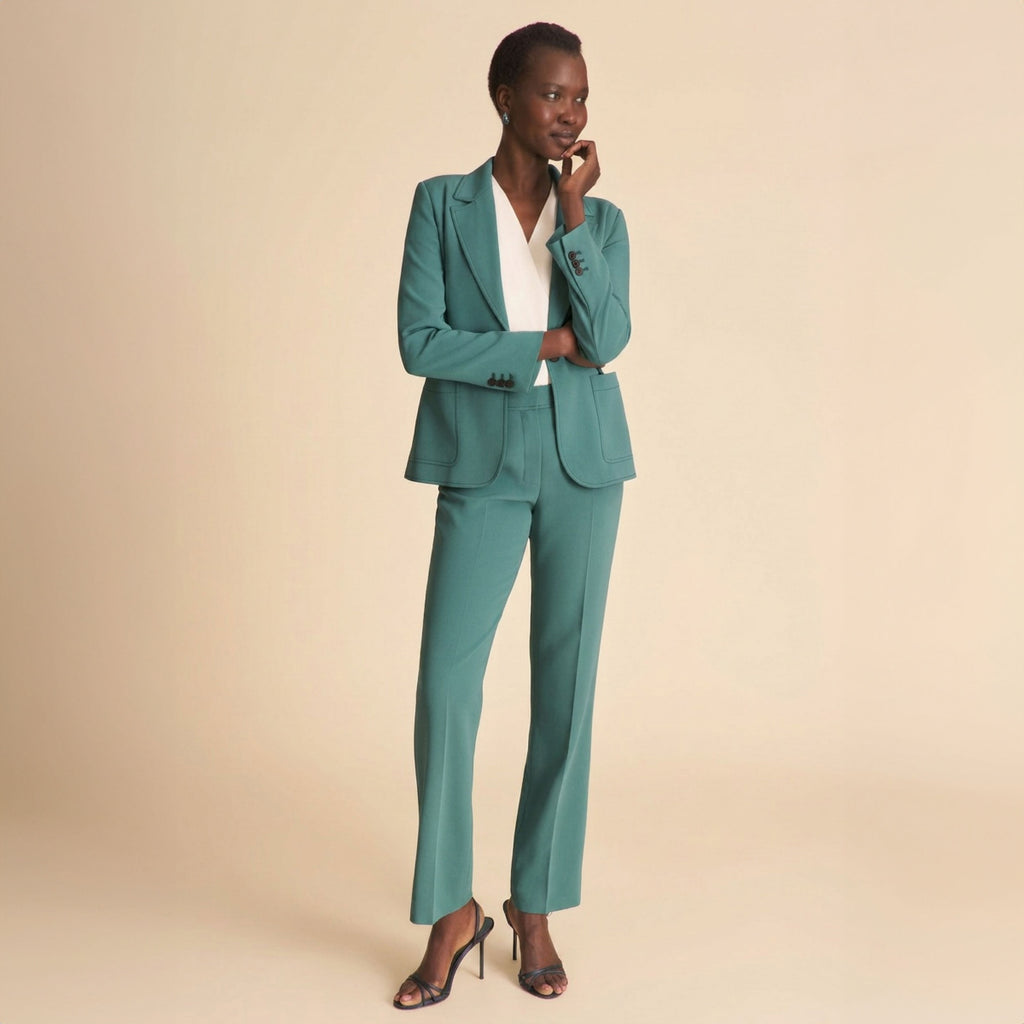 woman in teal blazer with black jeans