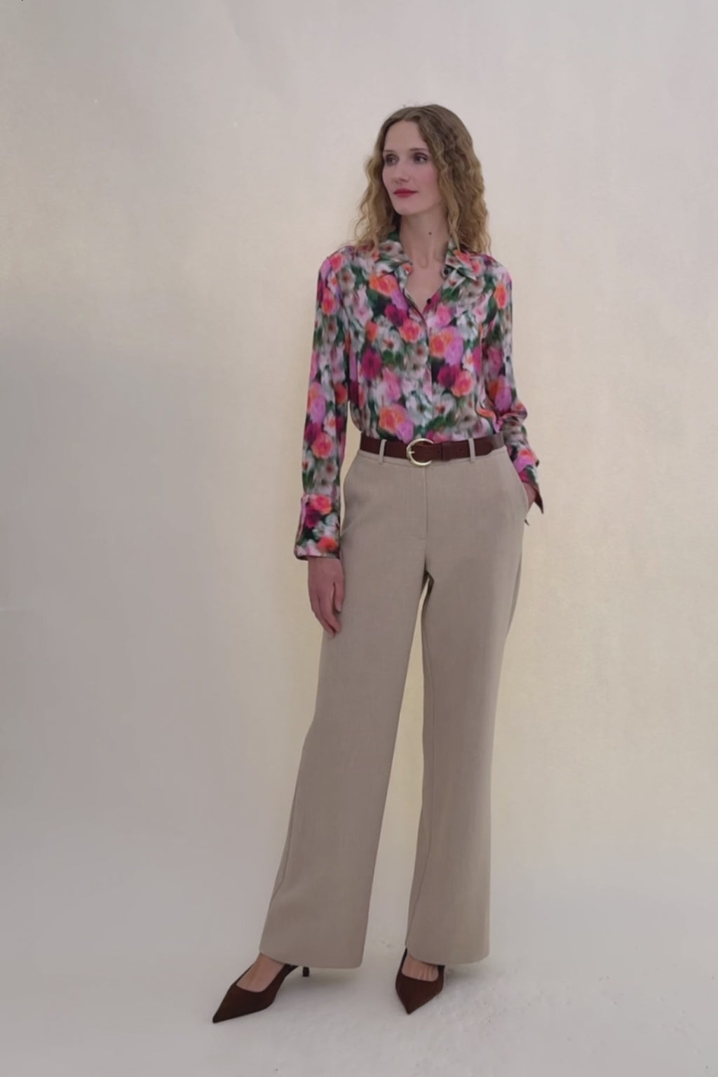 Woman in Floral shirt with beige pants. 