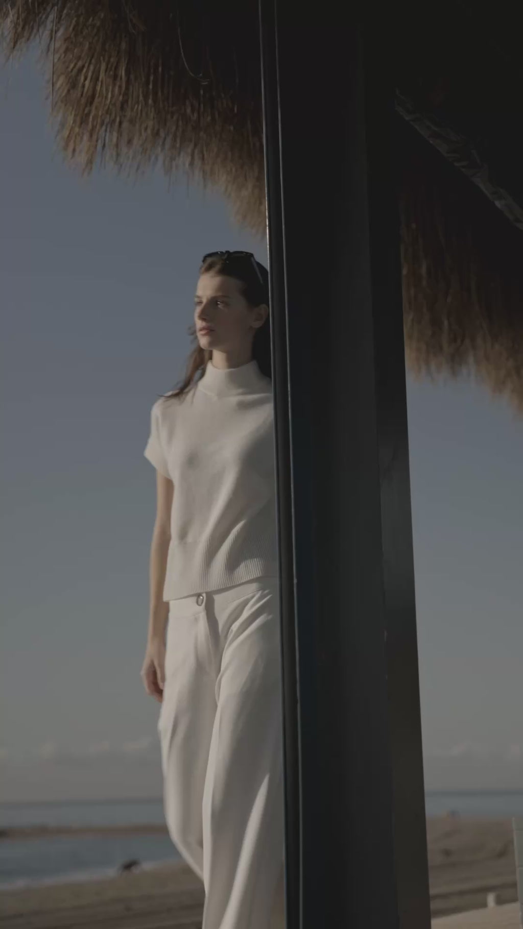 woman in all white walking outside.
