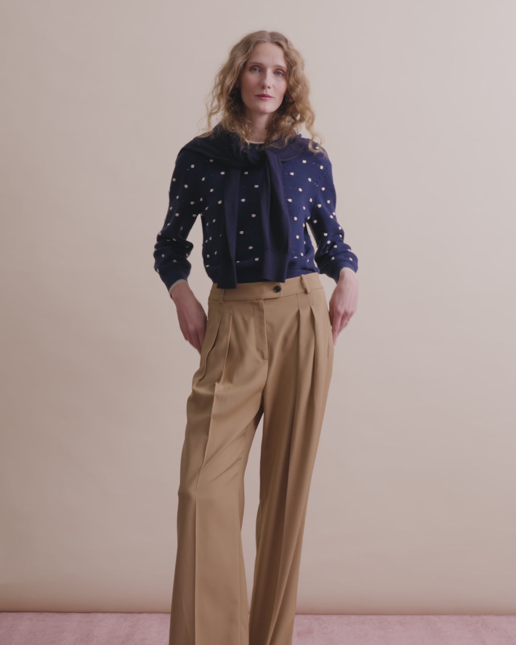 woman in polk a dot sweater with kaki pants.