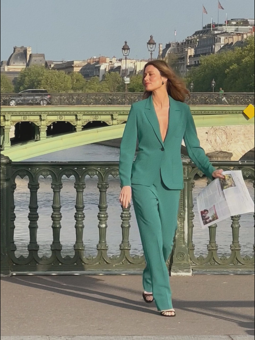 woman in teal blazer with matching pants.