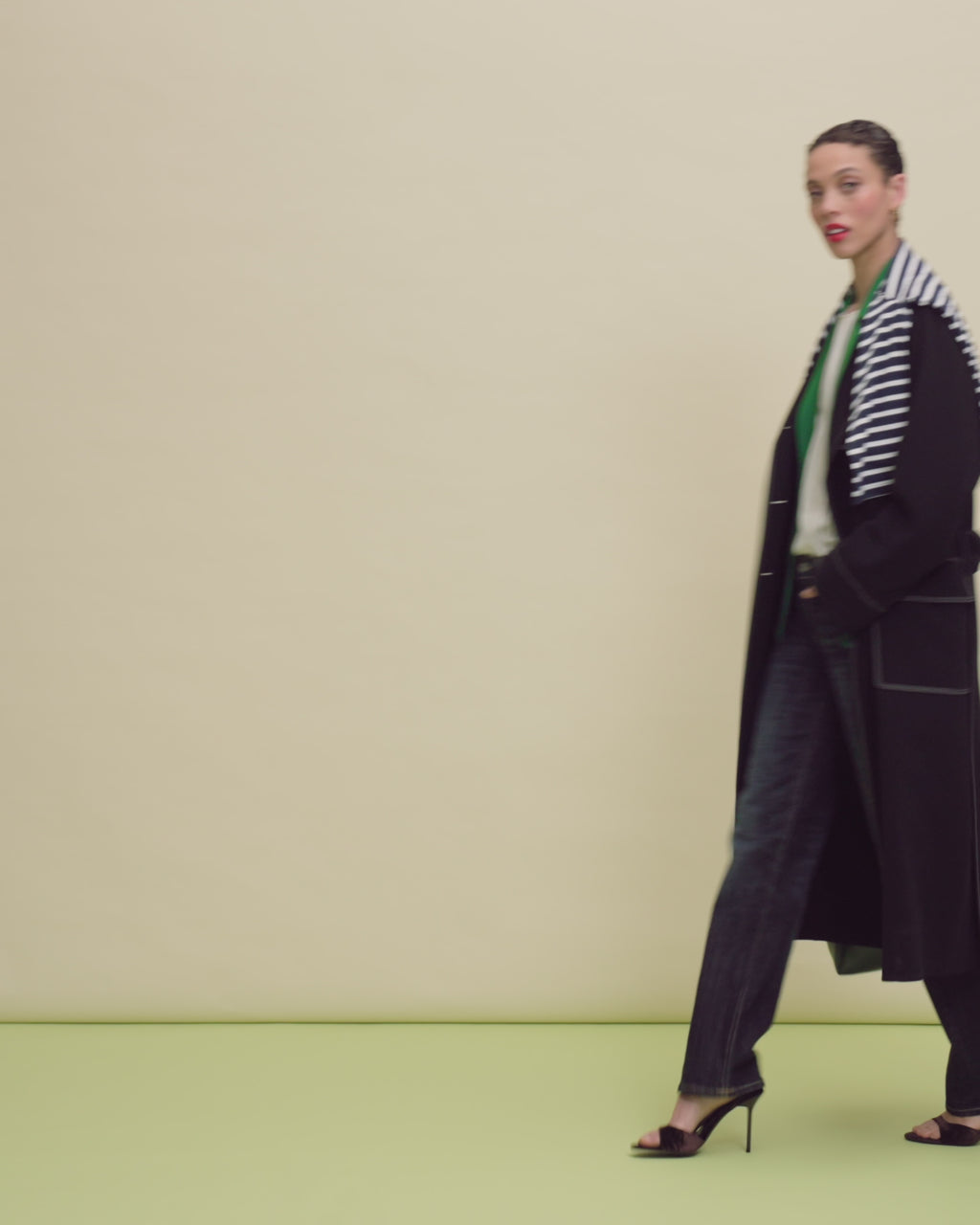 woman in blue jeans and black coat.