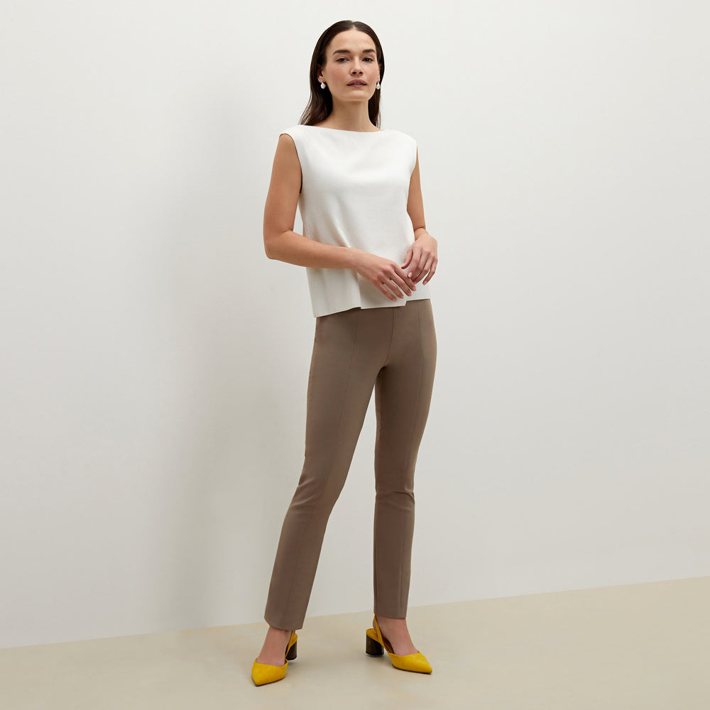 Side image of a woman standing wearing the foster pant in russet
