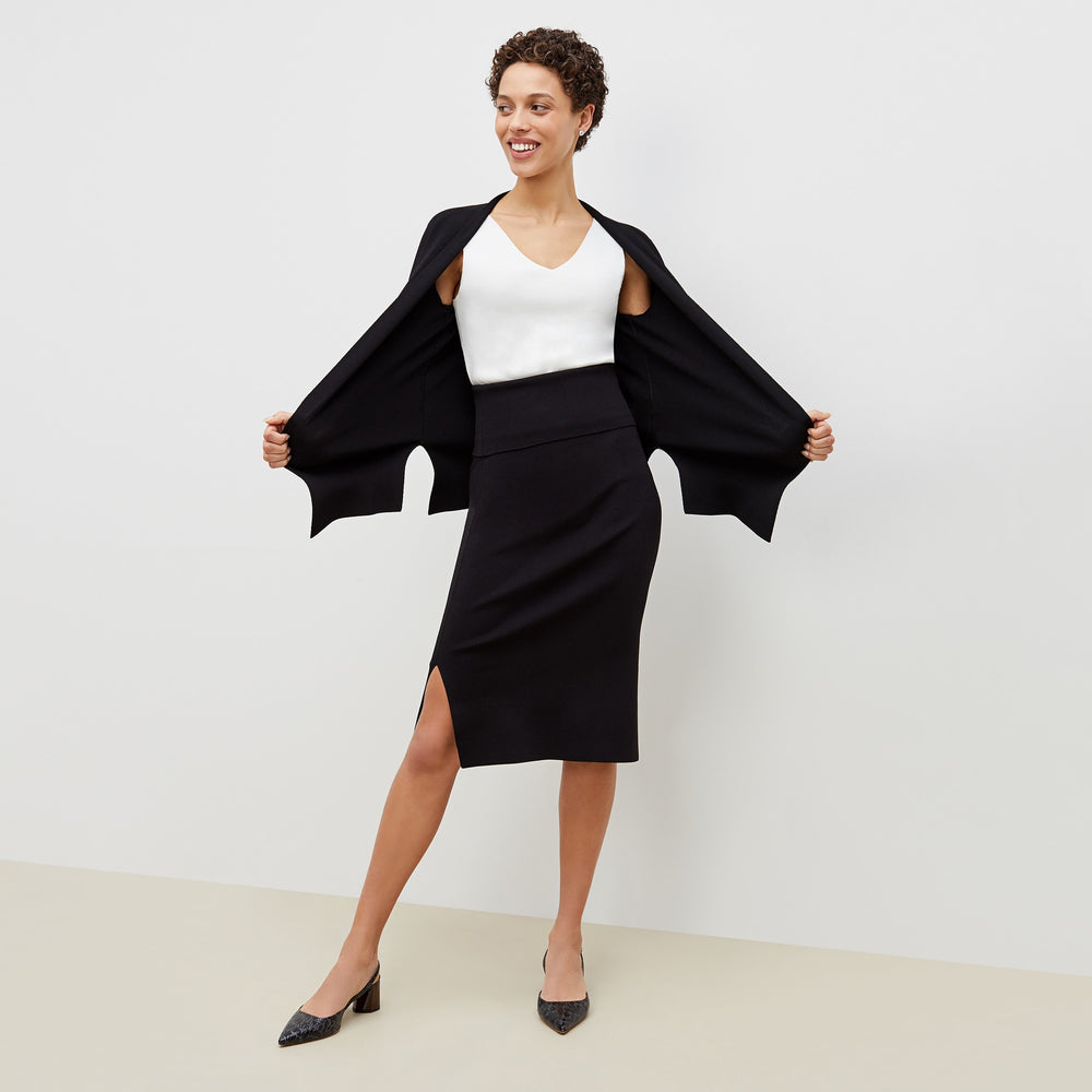 Front image of a woman standing wearing the harlem skirt in black