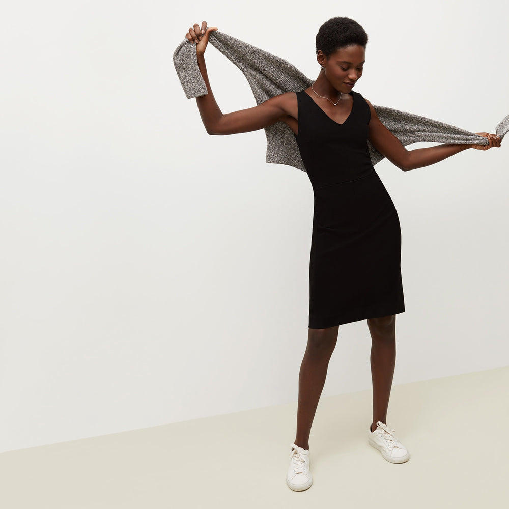 Front image of a woman standing wearing the Rachel dress in black