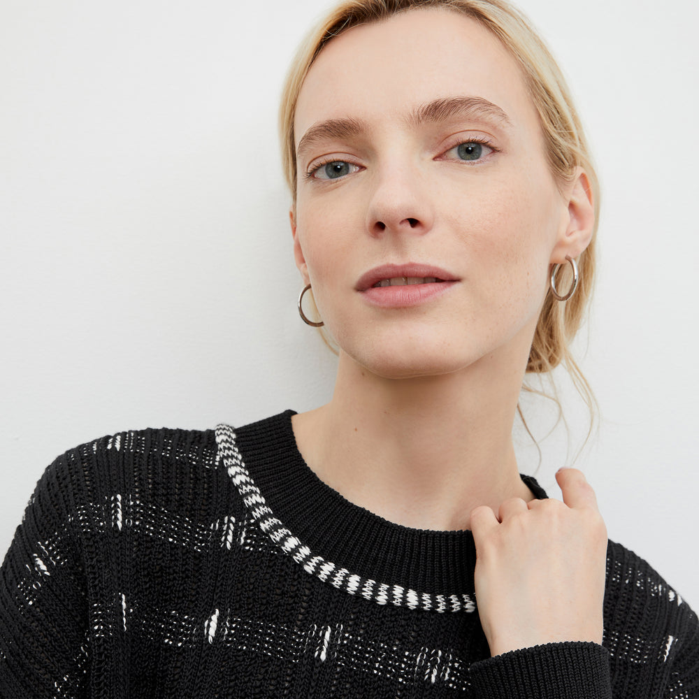 Front image of a woman standing wearing the Claressa Earrings in Silver